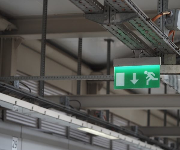 Emergency,Exit,Sign,In,A,Modern,Building,Near,A,Corridor